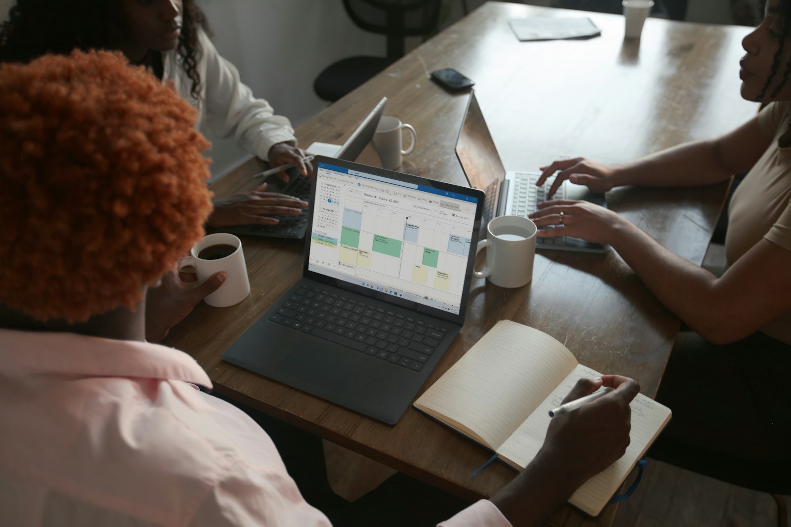 Colleagues going over a schedule on a laptop.